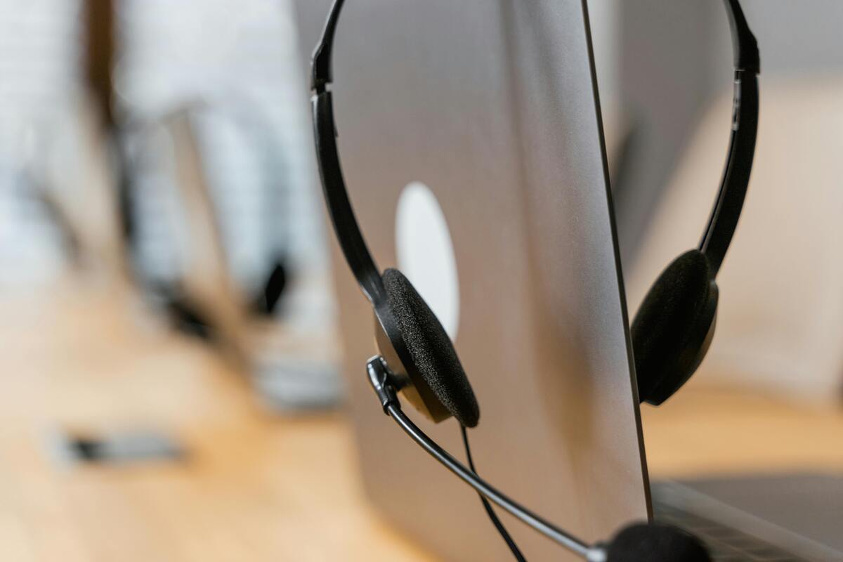 Headset beside a computer representing Enlaze Communications’ intake support for law firms, including client calls, lead follow-up, and appointment coordination.