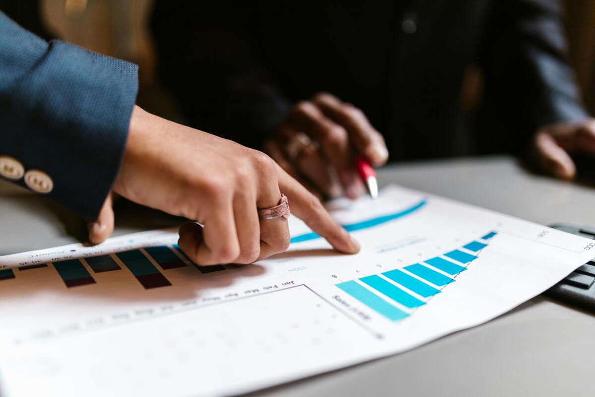 Professionals reviewing growth charts and performance reports representing Enlaze Communications’ support services for growing law firms that need more structure, capacity, and operational support.