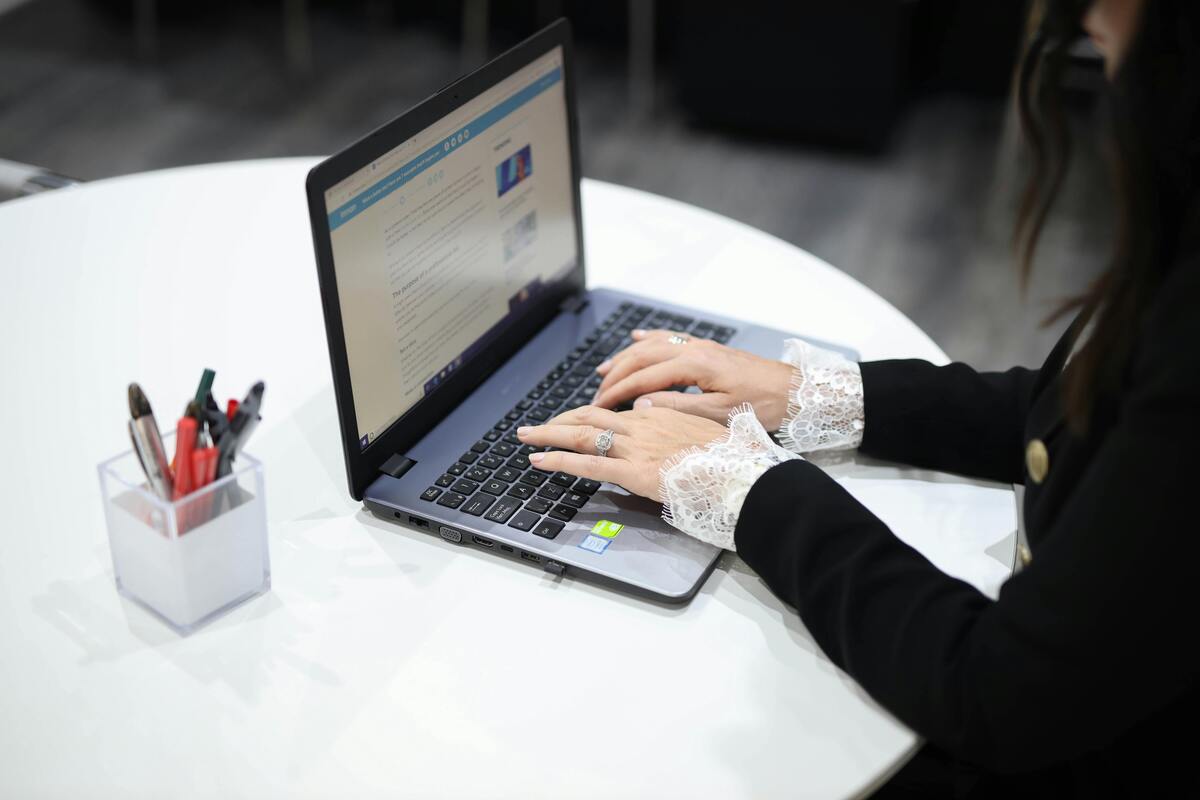 Person typing on a laptop representing Enlaze Communications’ virtual administrative assistant support for U.S. law firms.