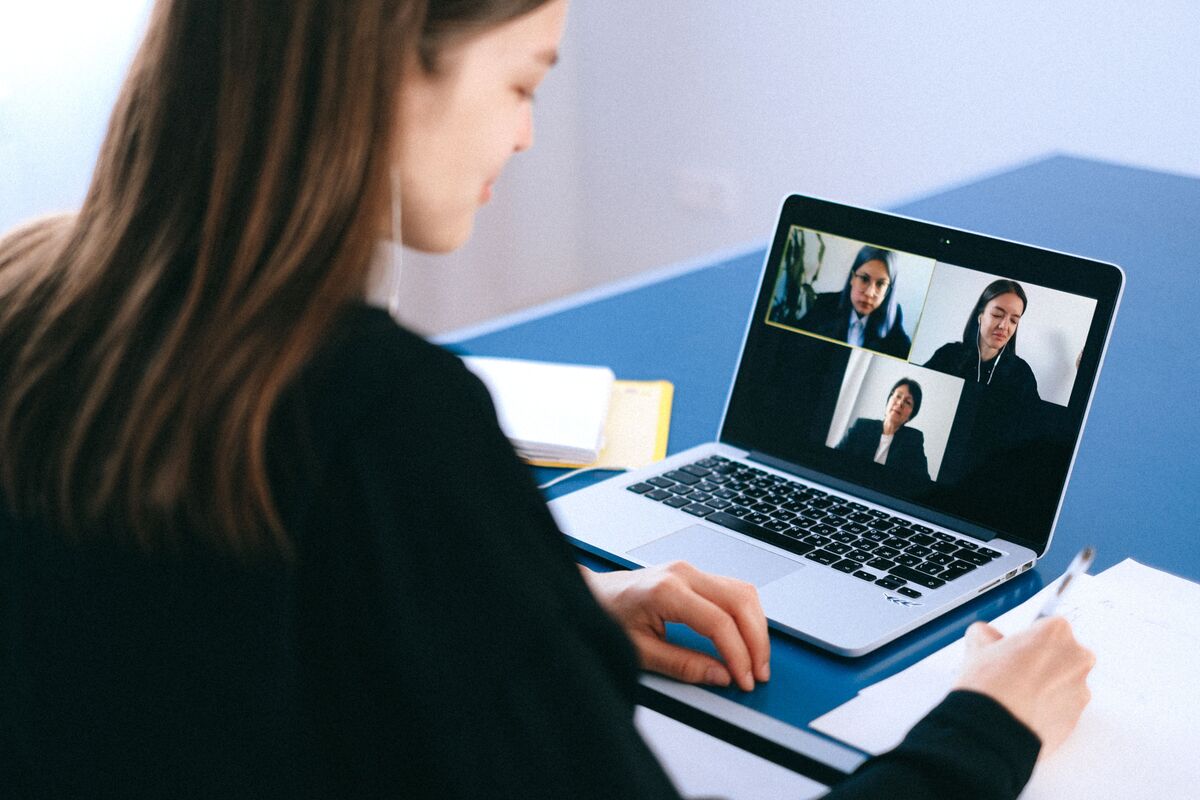 Bilingual administrative assistant participating in a professional video meeting with English- and Spanish-speaking clients.