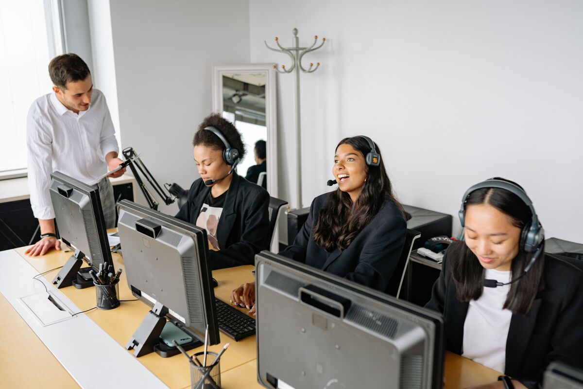 Enlaze supervisor collaborating with virtual legal assistants in a professional office environment