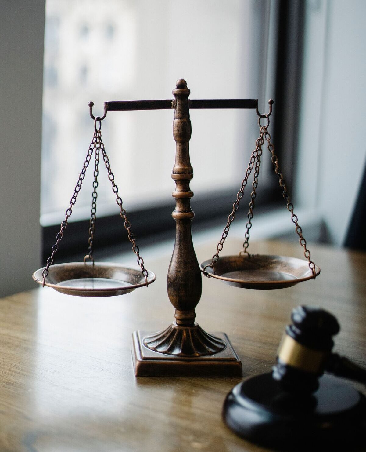 Scales of justice and a judge’s gavel representing support for U.S. law firms